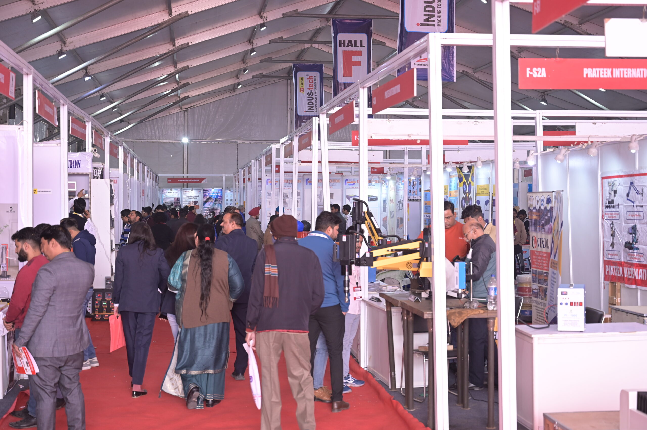 Busy indoor exhibition aisle with visitors