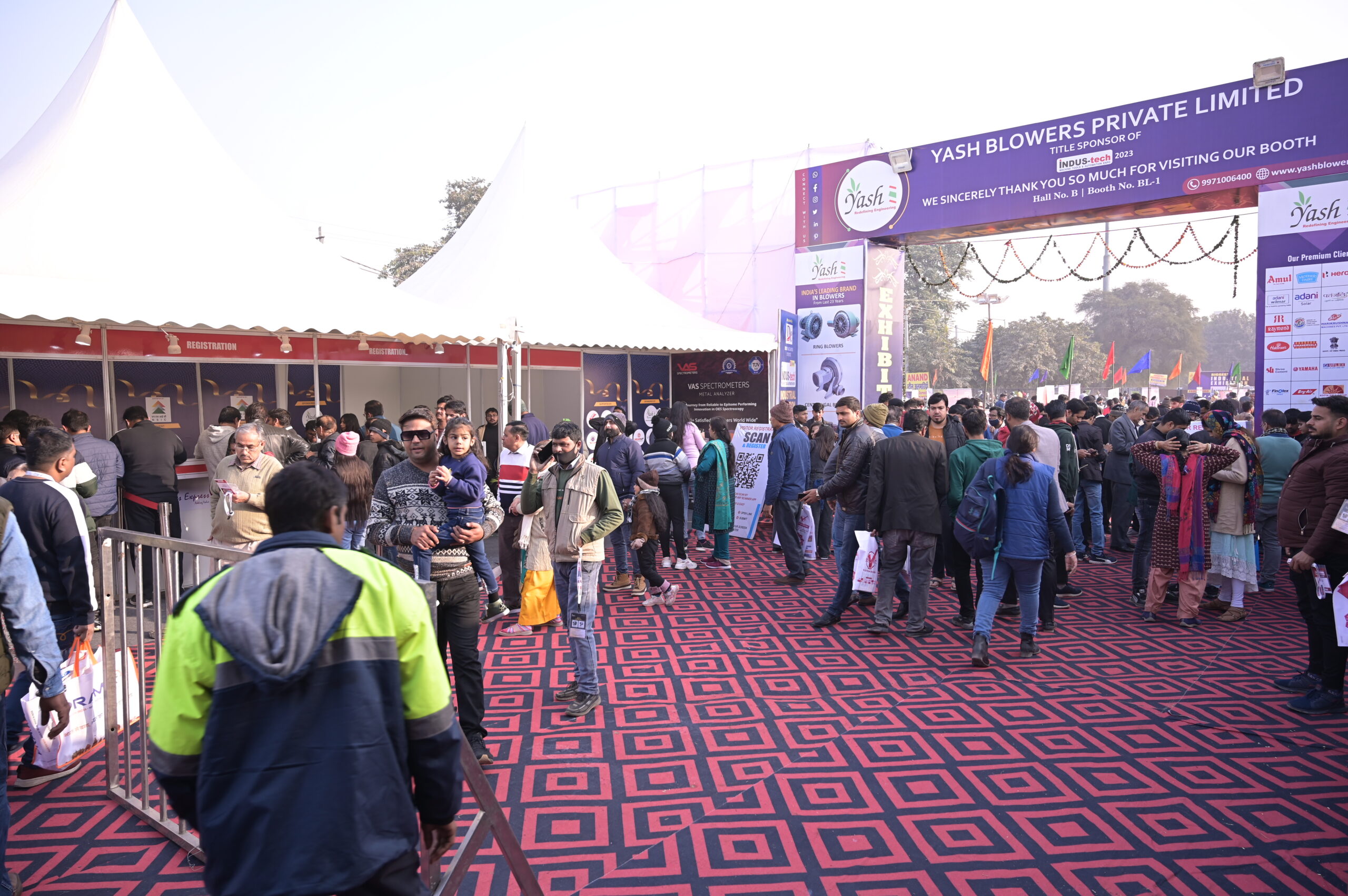 Indoor exhibition hall with visitors walking through