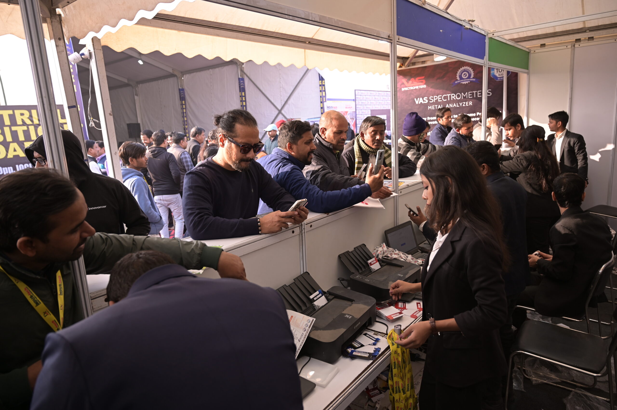 Busy registration counter visitors collecting badges
