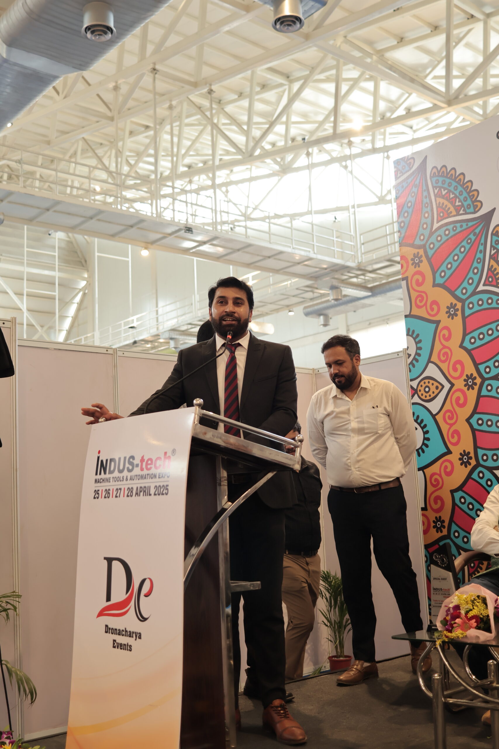 Organizer addressing audience at podium Kolkata expo