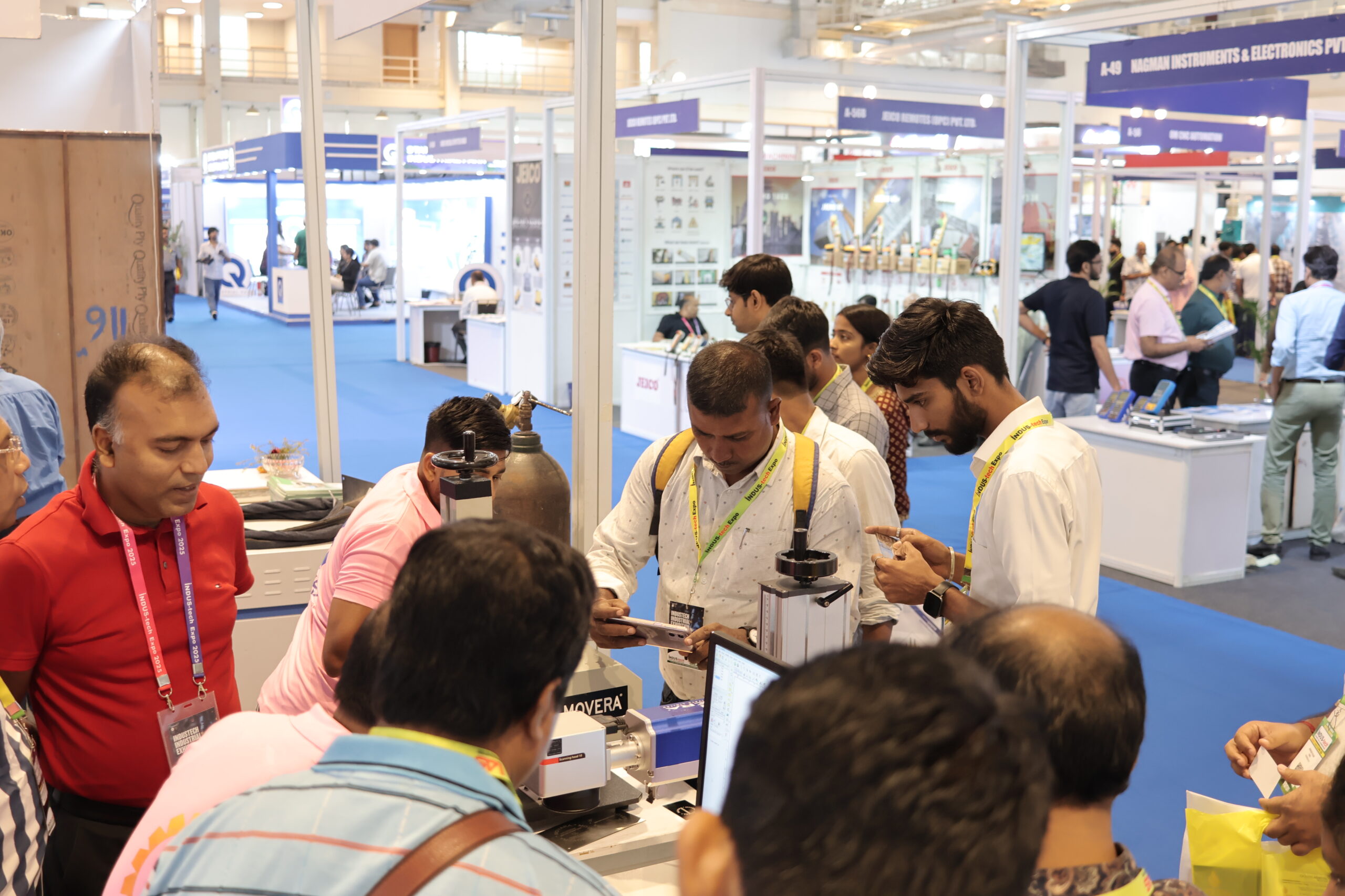 Visitors closely examining instruments at Movera stall