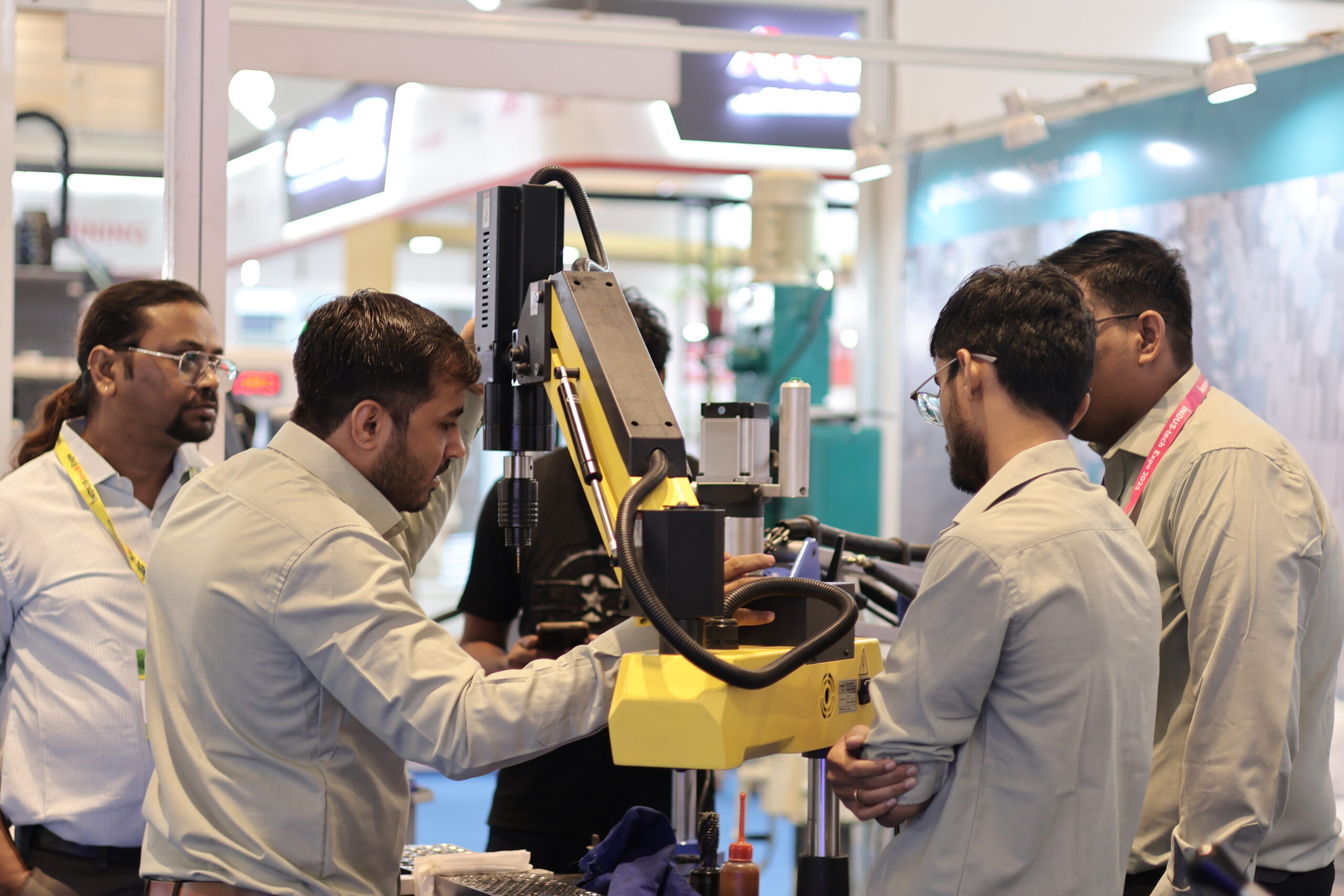 Visitors hands-on with yellow robot arm live demo