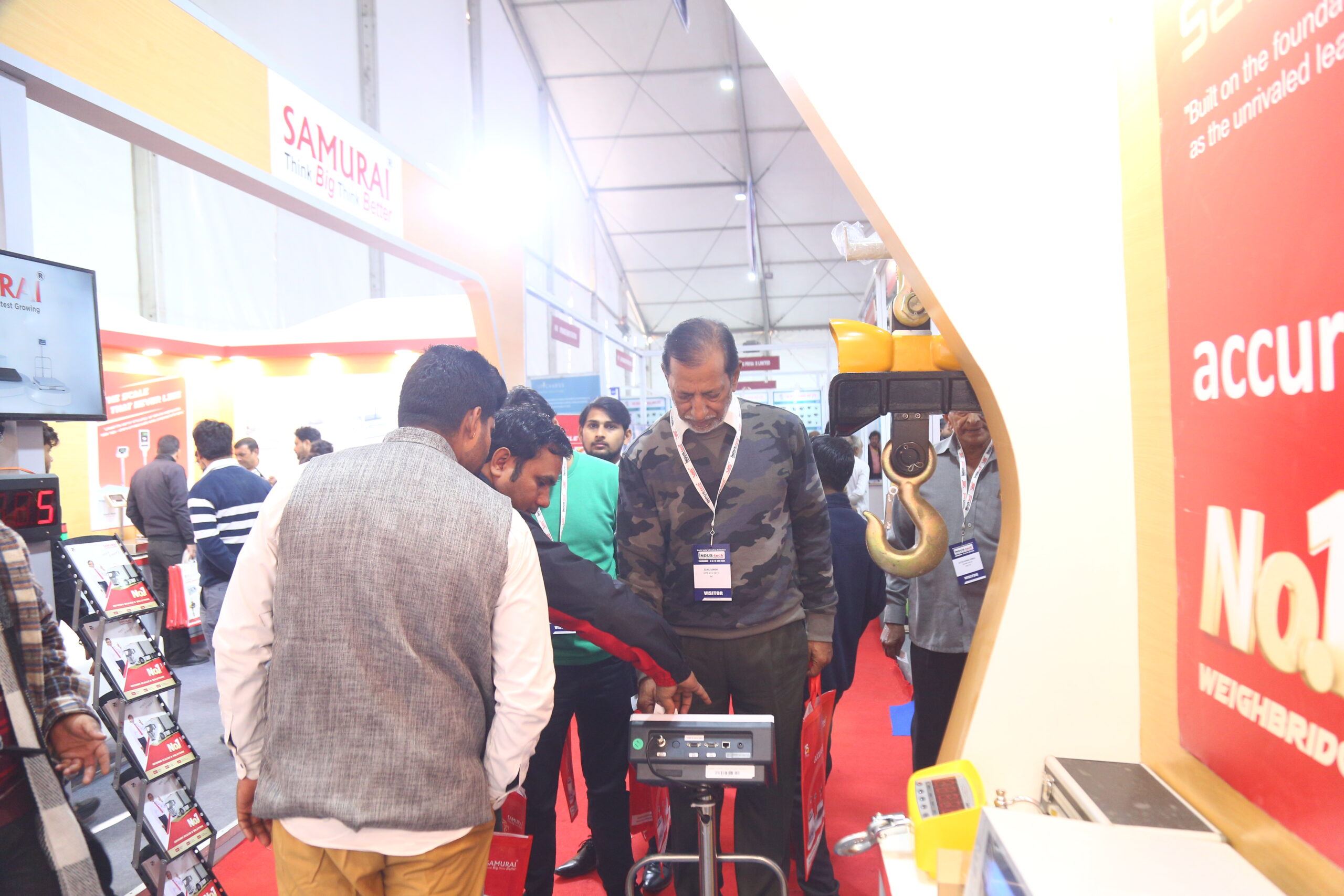Visitors examining weighing equipment at Samurai stall