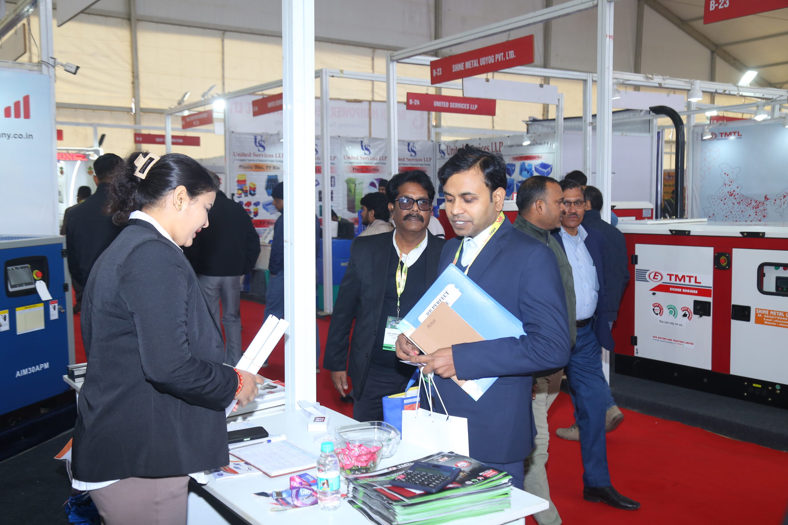 Visitors in discussion with exhibitor at stall