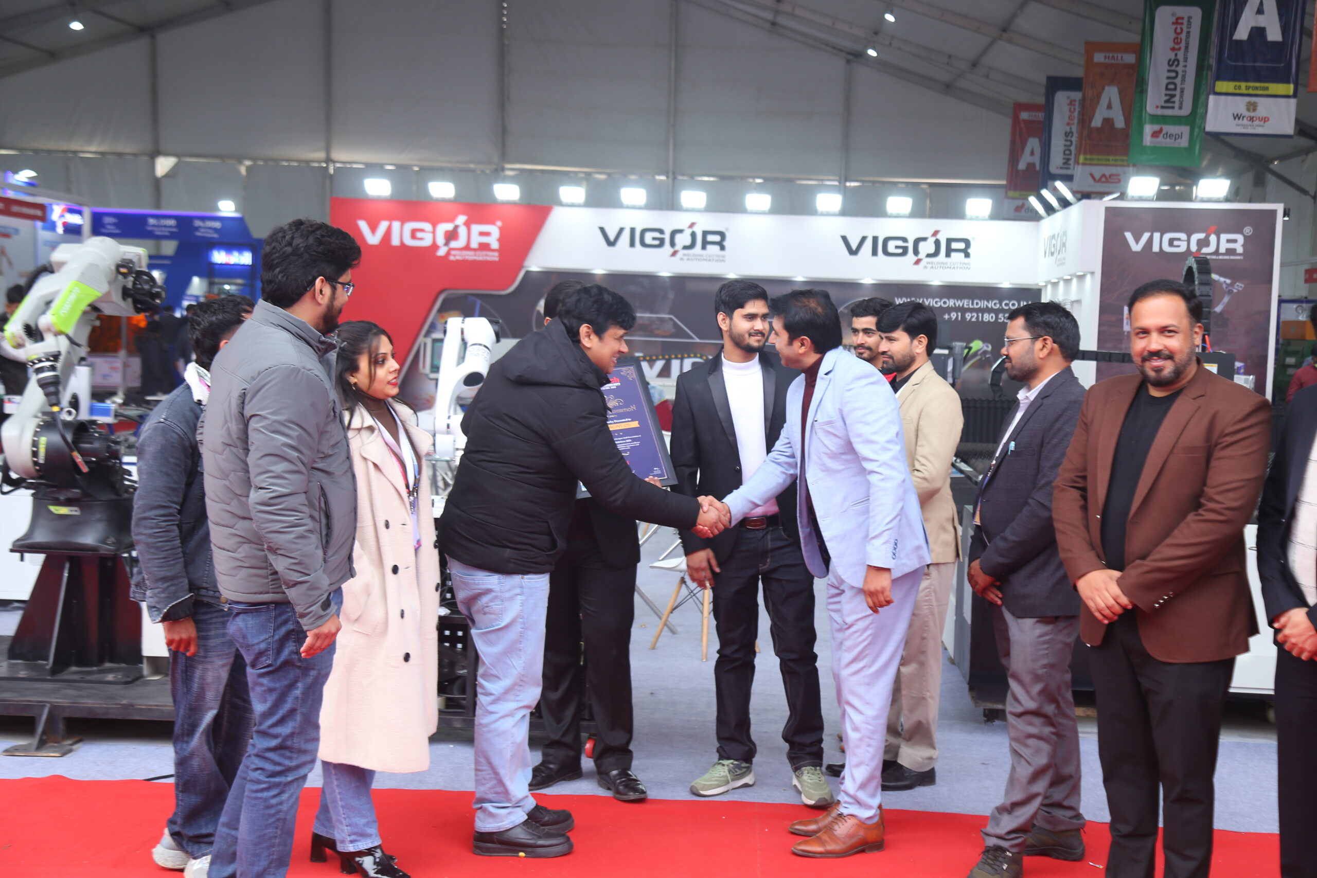 Award and handshake ceremony at Vigor welding stall
