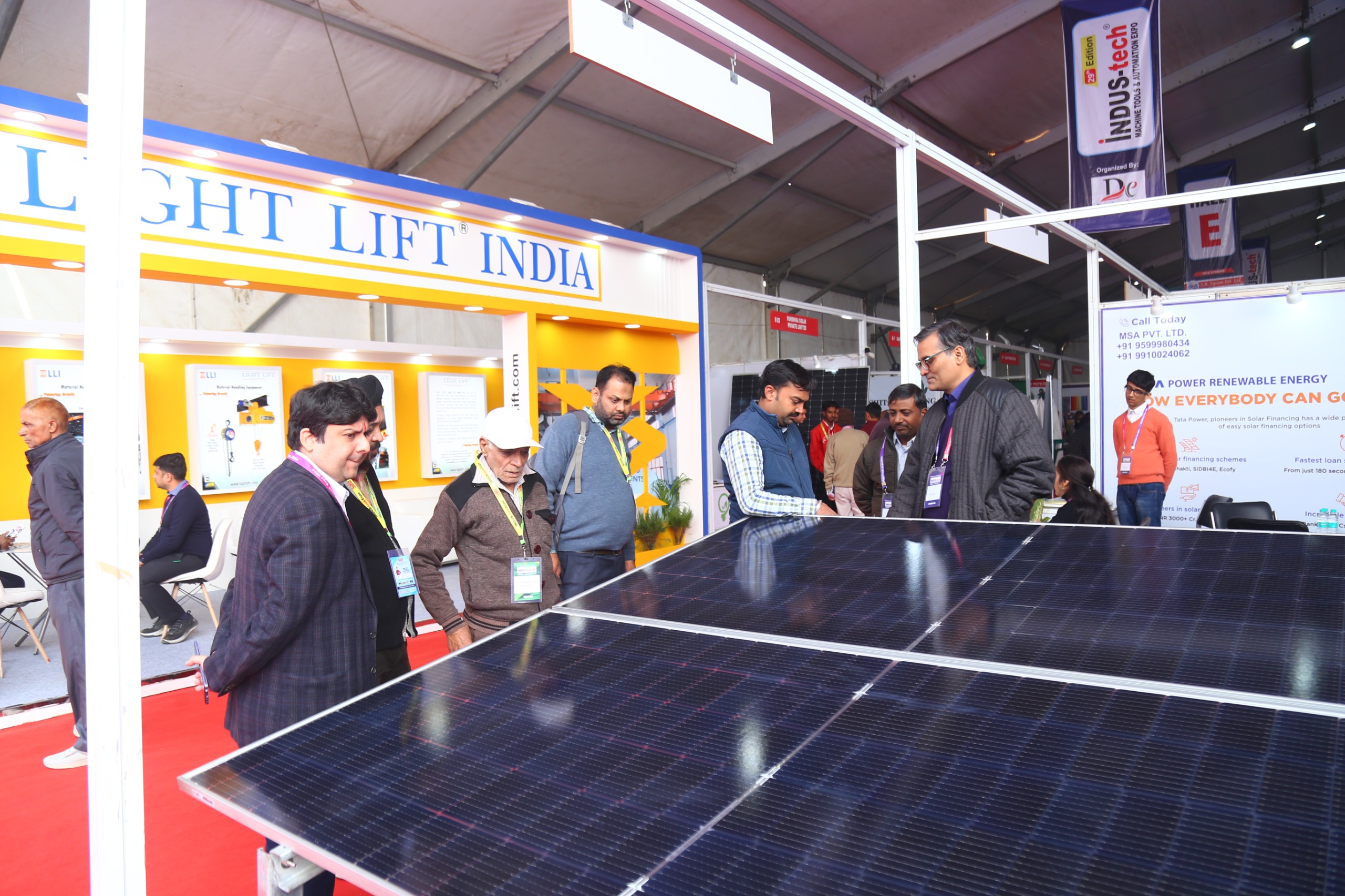 Visitors examining solar panels exhibitor stall display