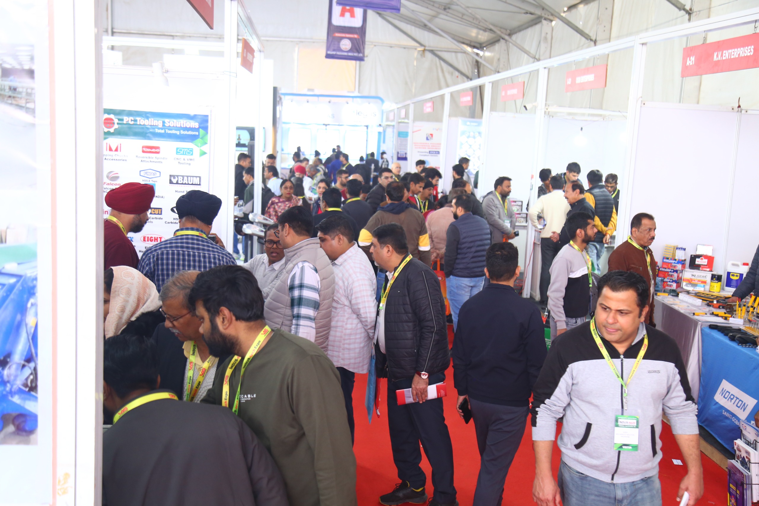 Packed exhibition hall dense crowd in aisles
