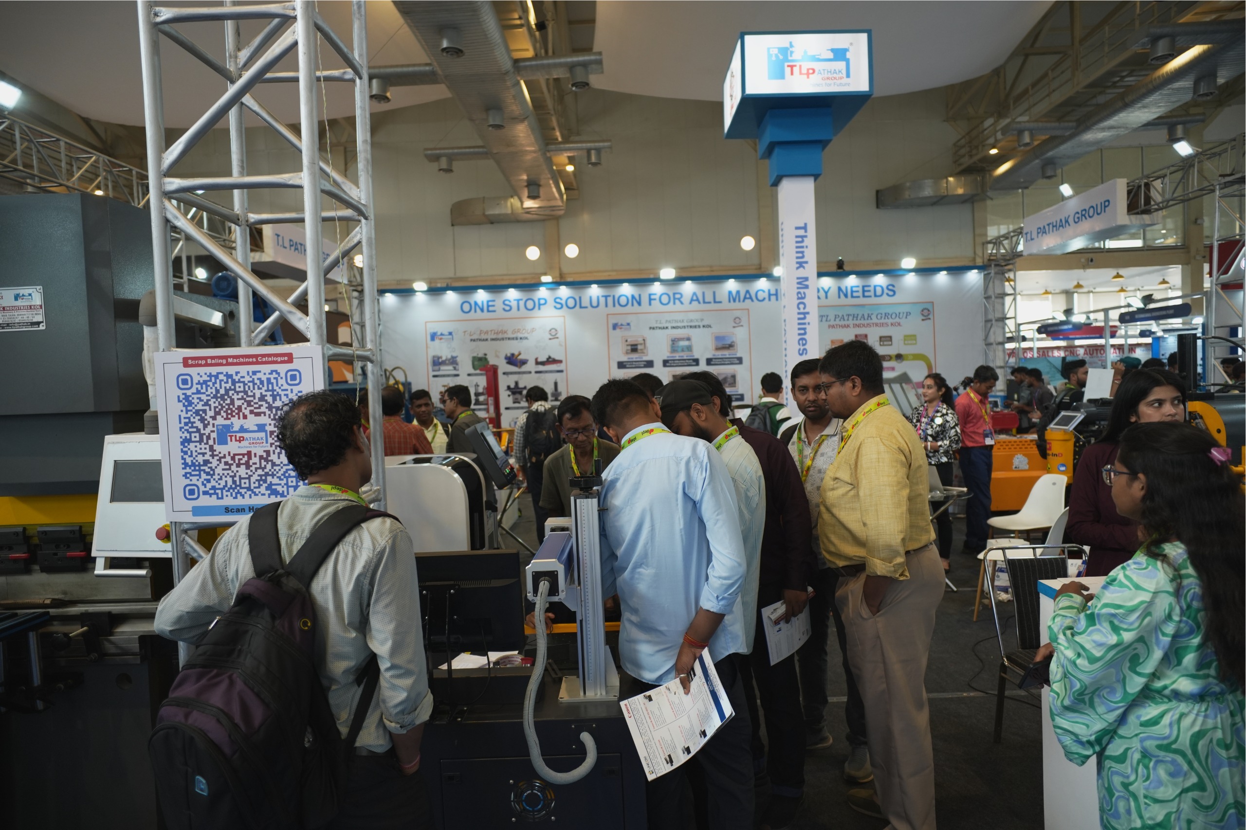 Visitors examining machines at TL Pathak Group stall Kolkata